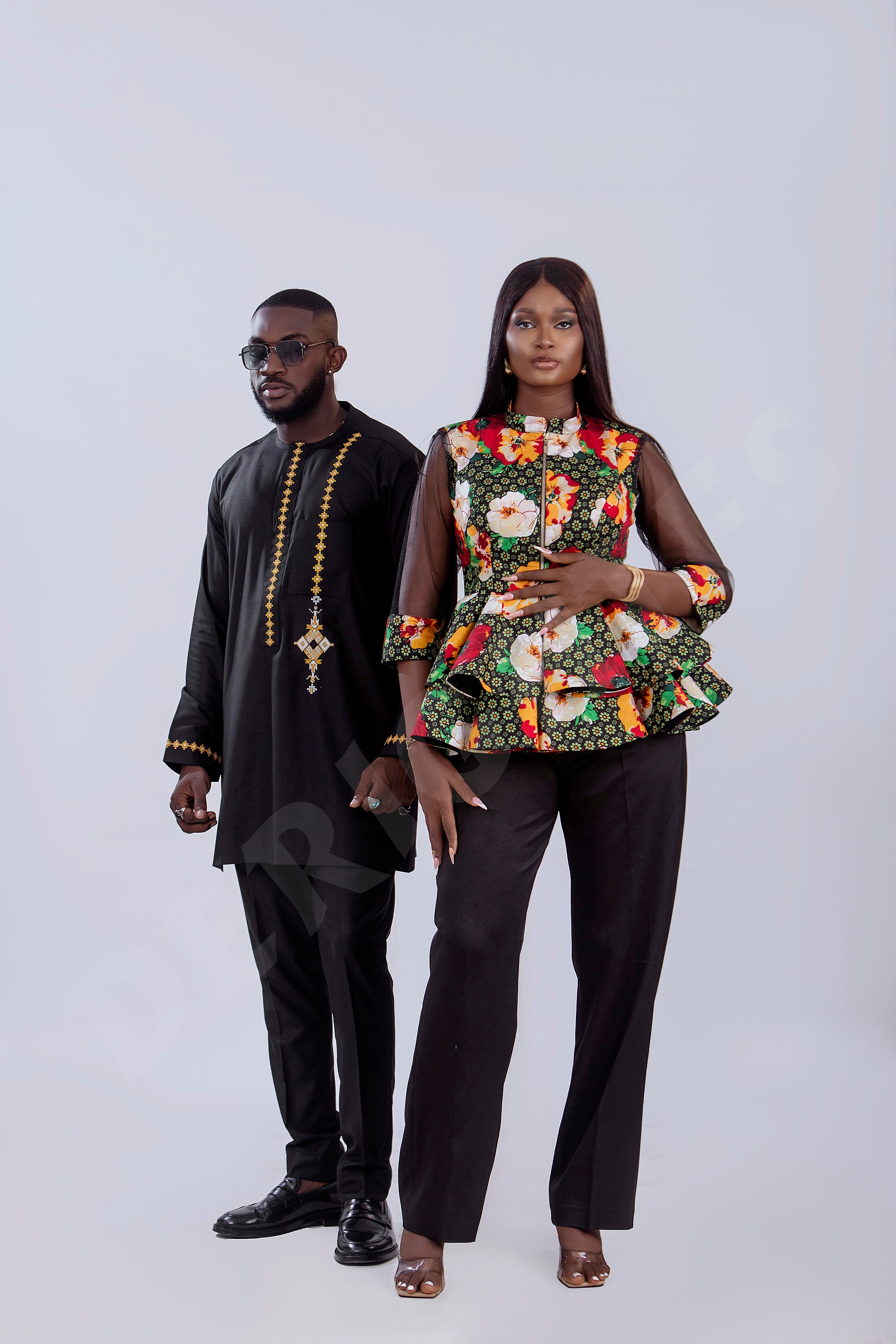 Elegant Black Men's Traditional Outfit with Intricate Embroidery.
