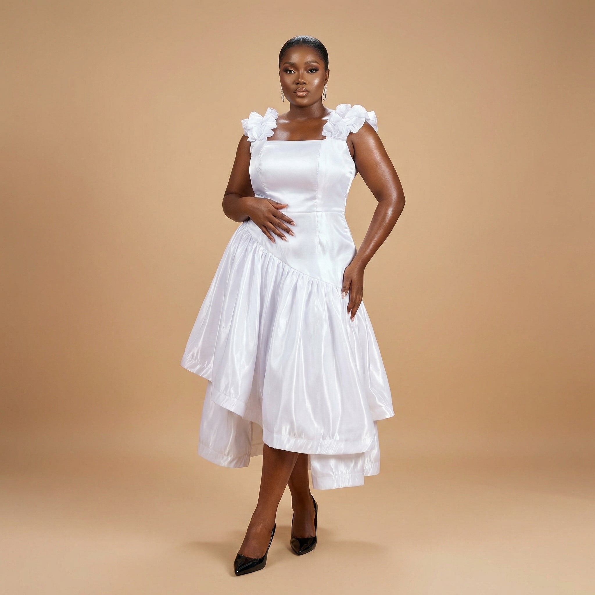 Woman wearing a white dress with floral details on a beige background, ready to wear.