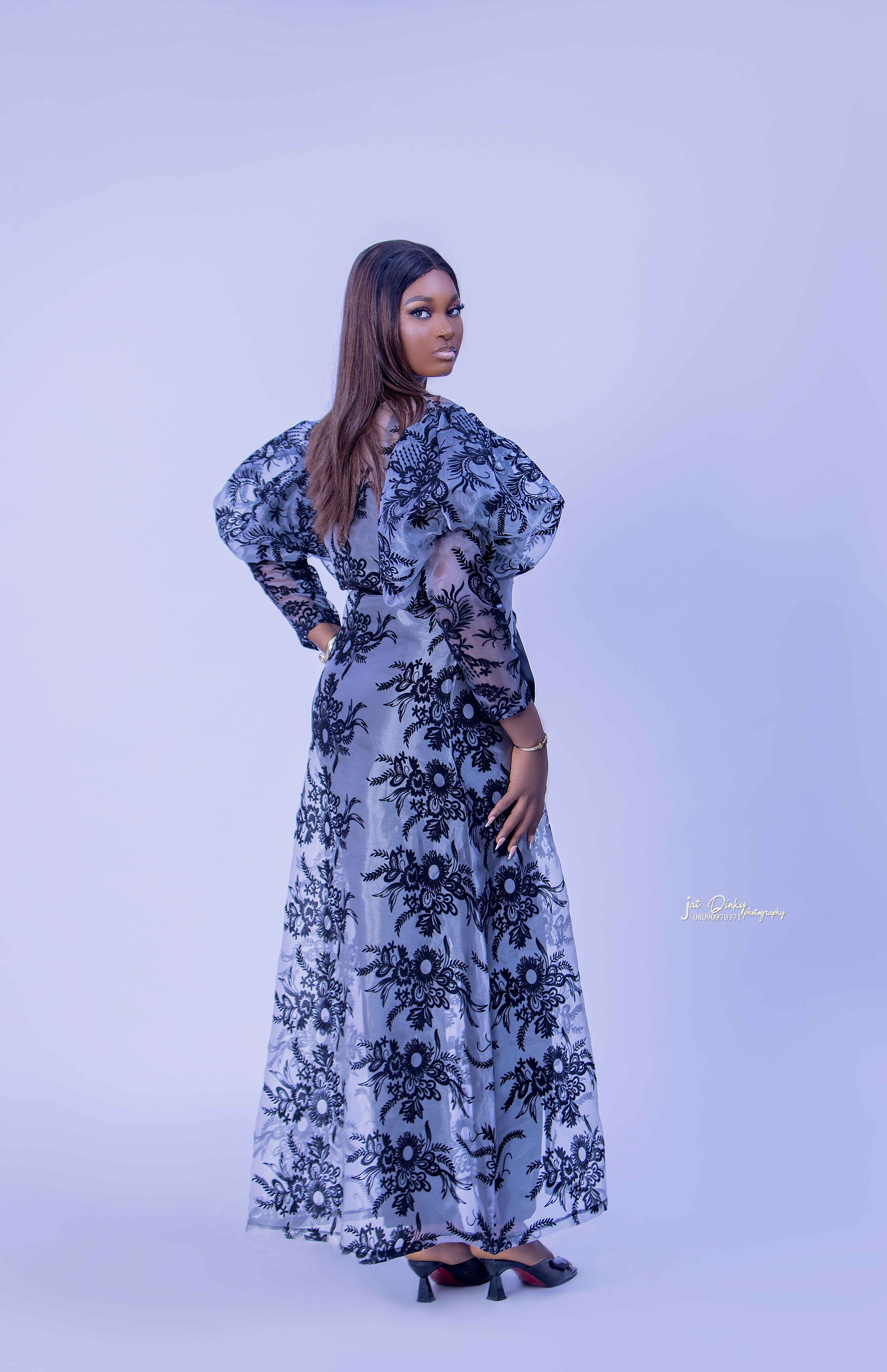 A woman wearing a two-piece organdi outfit with floral patterns, posing against a neutral background. Ready to wear.